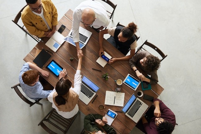 Top 10 Cities Perfect for Young Entrepreneurs people around a table